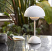 Matte White &Tradition VP9 Flowerpot Portable Table Lamp on table outside.