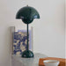 Green &Tradition VP3 Flowerpot Table Lamp on ledge.
