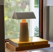 Silk Grey &Tradition MF1 Caret Portable Table Lamp on a Stack of Books by a Window