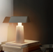 White &Tradition MF1 Caret Portable Table Lamp Illuminating Books in a Dark Setting
