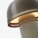 Close up image highlighting details of the bronzed metal shade of the Beige gray and bronze &Tradition SH8 Raku Portable Lamp