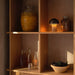 Beige grave and bronzed &Tradition SH8 Raku Portable Lamp on a Shelf in kitchen