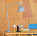 Midgard Modular Clamp Lamp 552 positioned on a home office desk, serving as a task lamp for focused work.
